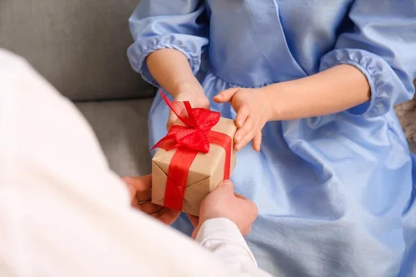 Woman receiving gift from her boyfriend at home. Valentine\'s Day celebration