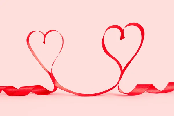 Hearts Made Red Satin Ribbon Pink Background Valentine Day Celebration — стокове фото