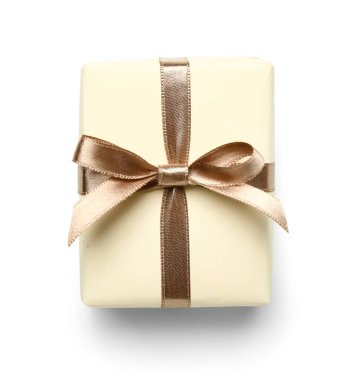 Gift box tied with silk ribbon on white background