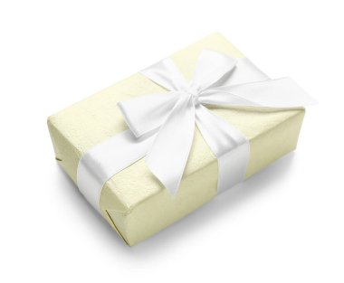 Gift box wrapped in yellow paper on white background