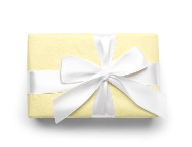Gift box wrapped in yellow paper on white background