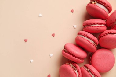 Tasty macaroons on beige background. Valentine's Day celebration