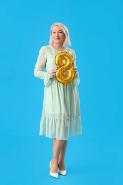 Beautiful mature woman with balloon in shape of figure 8 on light blue background. International Women's Day