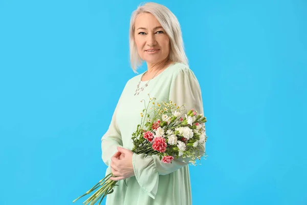 Beautiful Mature Woman Bouquet Flowers Light Blue Background — стоковое фото