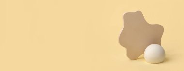 Empty modern podiums on light yellow background with space for text