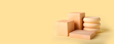 Empty modern podiums on yellow background with space for text