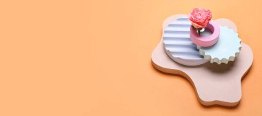 Empty modern podiums with flower on orange background with space for text