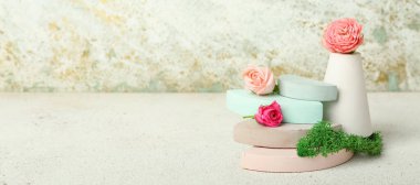Empty modern podiums with flowers on grunge background with space for text