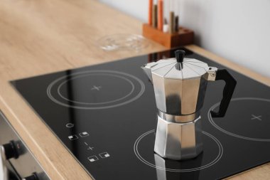 Geyser coffee maker on electric stove in kitchen