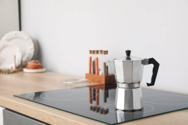 Geyser coffee maker on electric stove in kitchen