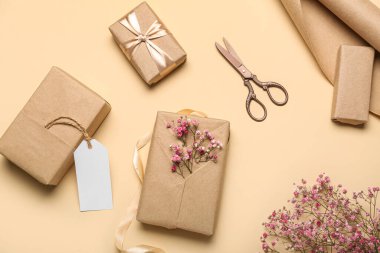 Composition with gift boxes, greeting card and gypsophila flowers for Women's Day celebration on color background