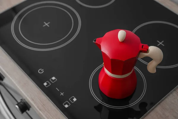 Geyser coffee maker on electric stove in kitchen