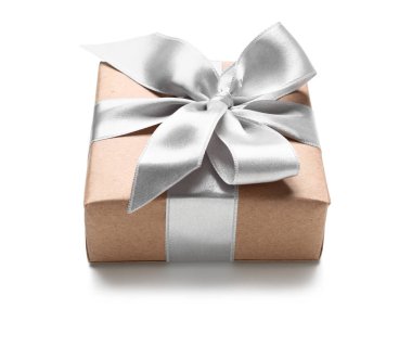 Gift box wrapped in craft paper with silk ribbon on white background