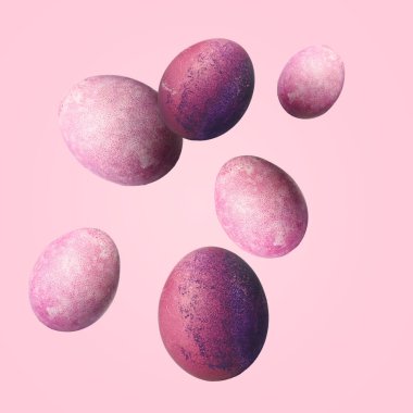 Beautiful flying Easter eggs on pink background