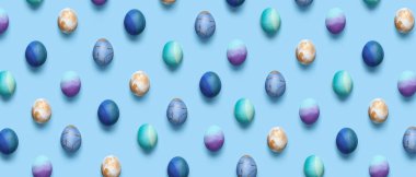Many beautiful Easter eggs on light blue background. Pattern for design