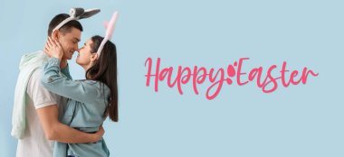 Easter banner with happy young couple in bunny ears on grey background