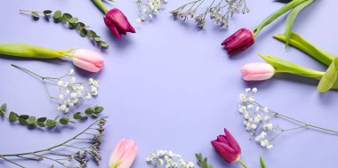 Round frame made of beautiful flowers on lilac background