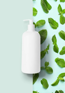Bottle of natural cosmetics with green mint leaves
