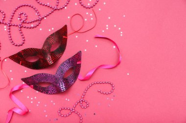 Carnival masks with stars and beads on pink background