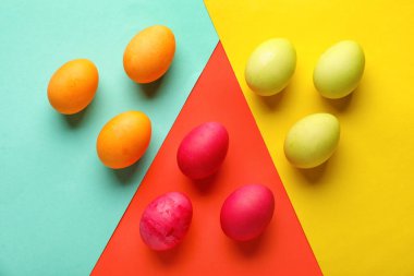 Composition with beautiful painted Easter eggs on color background