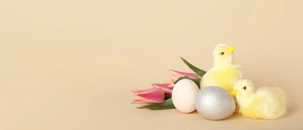 Cute chickens, tulips and Easter eggs on beige background with space for text