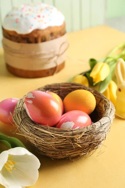 Nest Painted Easter Eggs Tulip Flowers Yellow Table Closeup — Stock Fotó