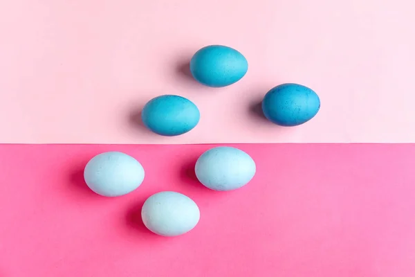 Composition with painted Easter eggs on pink background