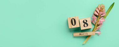 Calendar with date MARCH 8 and hyacinth flower on color background with space for text