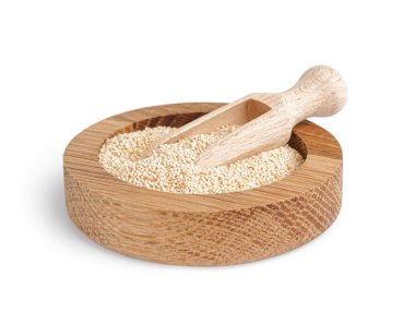 Wooden bowl of amaranth seeds and scoop on white background