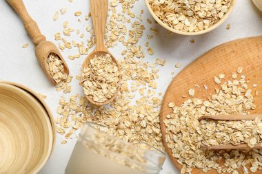 Composition with oatmeal flakes on light background