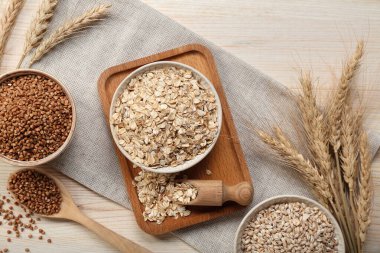 Composition with different cereals and spikelets on wooden background