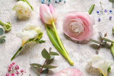 Composition with beautiful spring flowers on light background