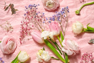 Composition with beautiful flowers on pink crumpled paper