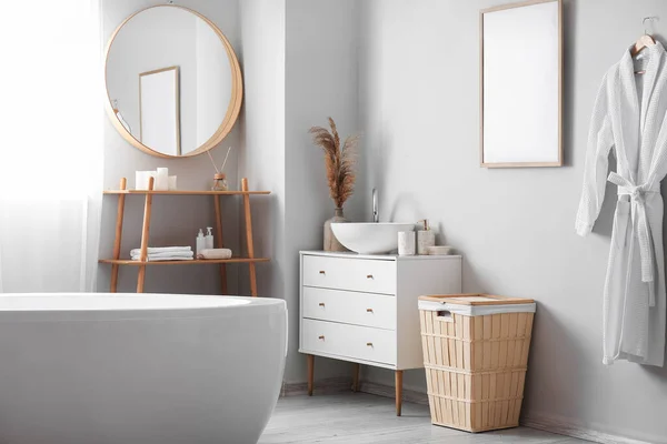 stock image Interior of light bathroom with drawers, shelving unit and basket