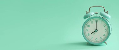 Vintage alarm clock on turquoise background with space for text