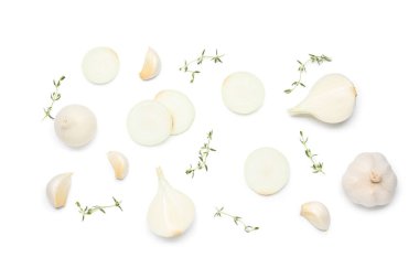 Composition with cut onion, garlic and thyme on white background