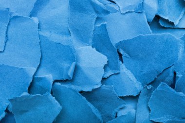 Torn pieces of blue paper as background, closeup