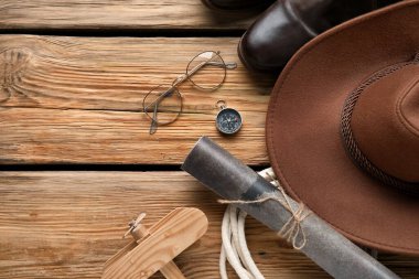 Compass with traveler accessories on wooden background