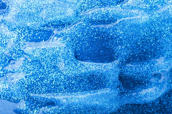 Blue glitter as background, closeup
