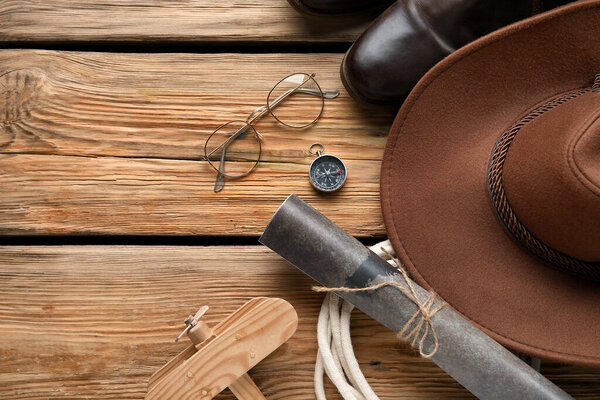 Compass with traveler accessories on wooden background
