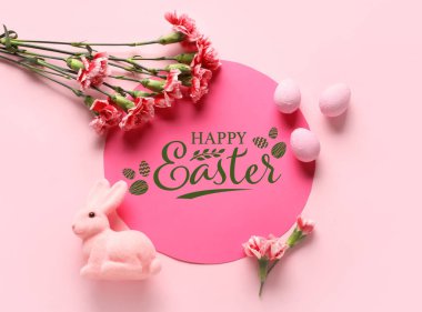 Greeting card, Easter eggs, toy rabbit and flowers on pink background