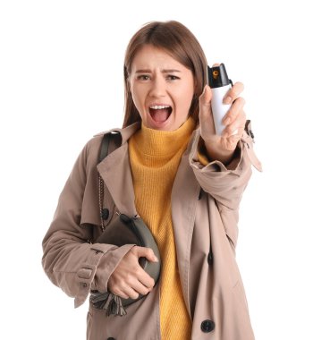 Scared young woman with pepper spray for self-defence on white background