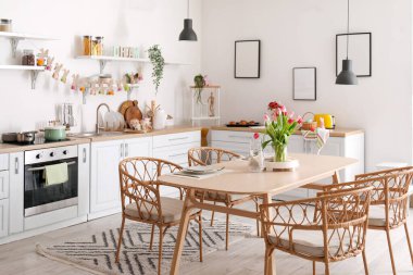 Interior of kitchen decorated for Easter celebration with dining table and counters