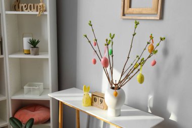 Stylish interior of light living room decorated for Easter celebration
