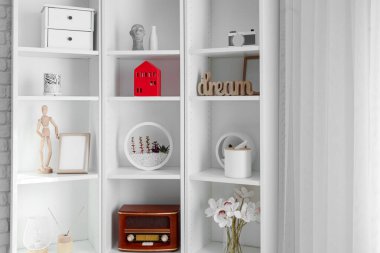 House candle holder on shelving unit in bright room