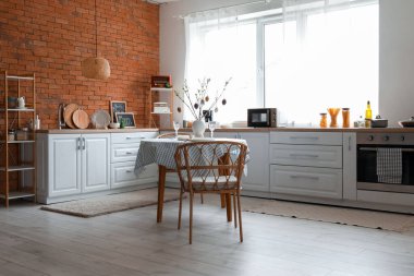 Interior of kitchen with Easter decor, counters and dining table