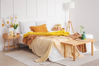 Interior of bedroom with tree branches, Easter eggs and rabbits