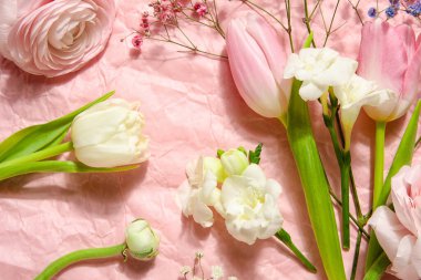 Composition with beautiful flowers on pink crumpled paper