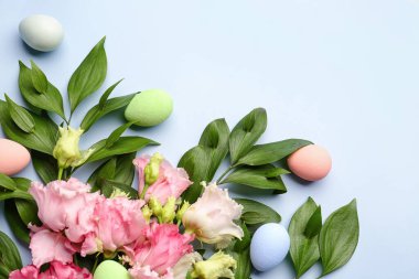 Composition with beautiful eustoma flowers, plant branches and Easter eggs on color background