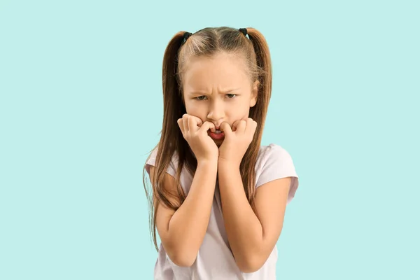 Little Girl Biting Nails Blue Background — Stock Photo, Image